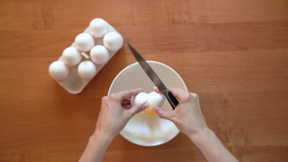 Breaking Egg Into A Bowl