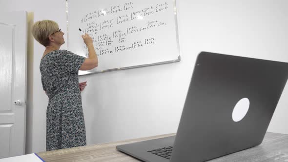 Aged Mathematics Teacher in Glasses is Preparing the Students to Exams