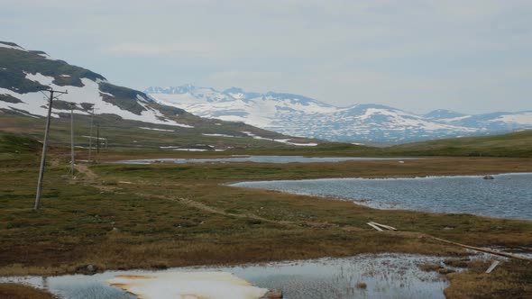 Panoramic View Of Calm Lake And Green Fields At The Jamtland Triangle (Jamtlandstriangeln) In Sweden alt