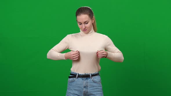 Young Woman Pushing Up Breasts at Chromakey Background alt
