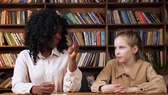 Individual Tutor Teaches Schoolgirl Letters with Flashcards alt