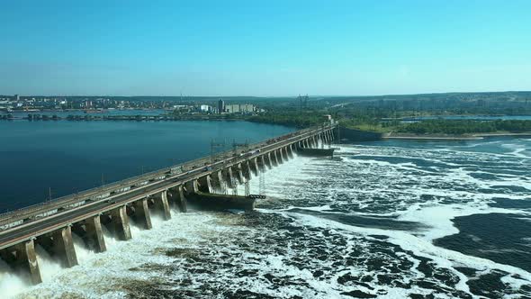 Aerial View of the River Dam, Boiling Water. Cars Go Over the Bridge Over the River Dam. Side View