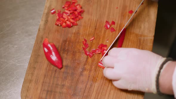 Closeup of chef chopping mushrooms in the kitchen