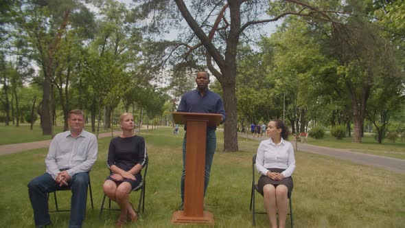 Positive Black Professor Giving Talk to Multiracial Graduates at Graduation Day alt