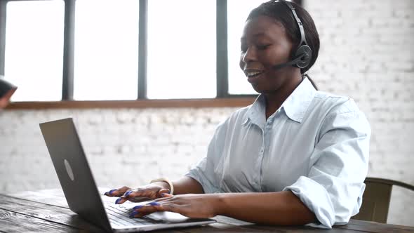 Female AfricanAmerican Support Worker Wearing Wireless Headset with Mic Talking