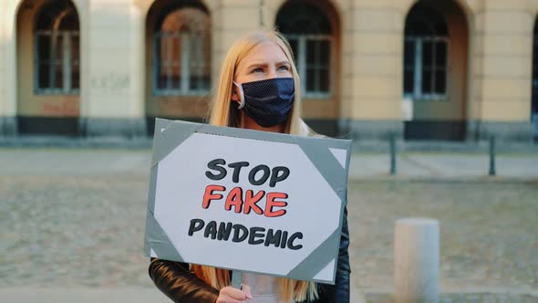 Young Woman in Protective Mask Protesting Against Fake Pandemic alt