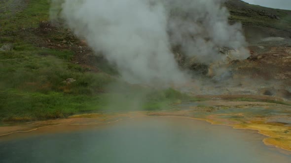 dramatic iceland landscape, geothermal hot spring pool steam smoke