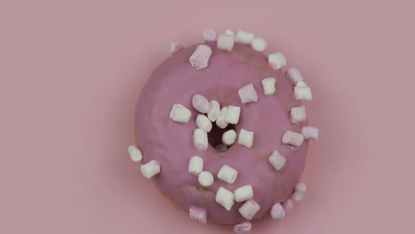 Sweet Donut Rotating on Pink Background. Top View. Tasty, Fresh Donut alt