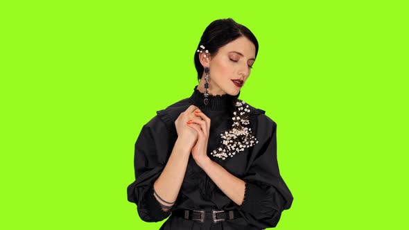 Portrait of Young Stylish Brunette Woman Singing Lyric Song on Green Background