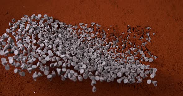 Peppers of Chocolate Falling in Chocolate Powder, Slow Motion 4K alt