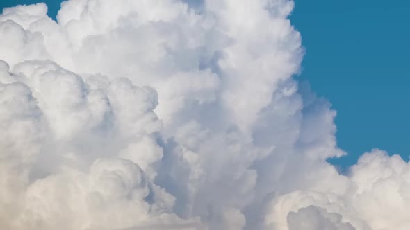 Timelapse of White Puffy Cumulus Clouds Forming on Summer Blue Sky alt