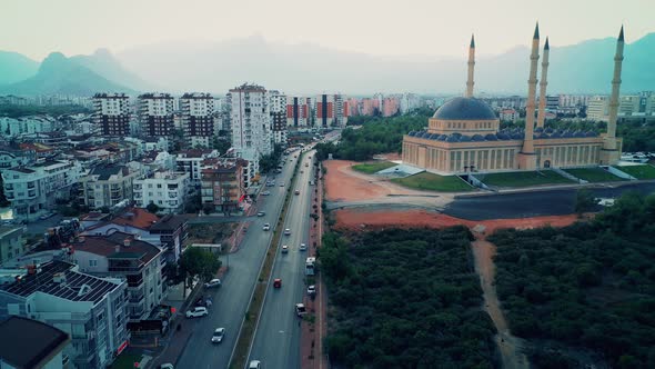 Slow Motion of Cars Driving on City Street Along Modern Buildings alt