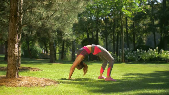 Fit Sporty Woman Doing Backbend Exercise Outdoors alt