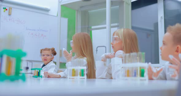 Group of Kids Making Experiments in Chemistry Class alt