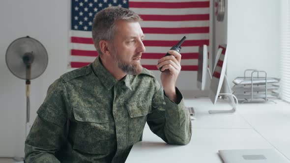Army Officer in Uniform Talking on Walkie-Talkie alt
