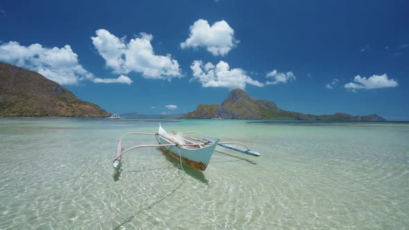 El Nido Bay. Palawan Island, Philippines. Slow Motion of Lonely Filippino Boat Floating in Calm Blue alt