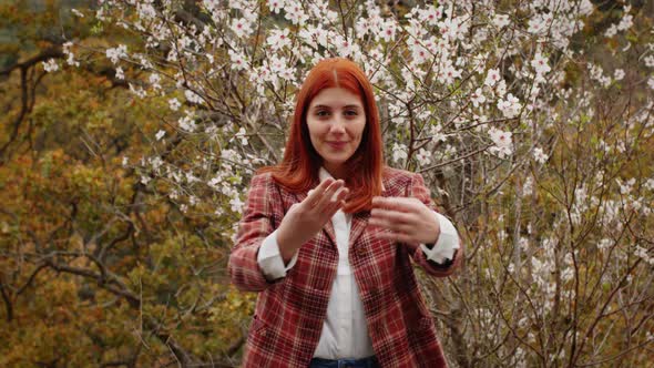 Happy Redhaired Girl Under Spring Flower Tree alt
