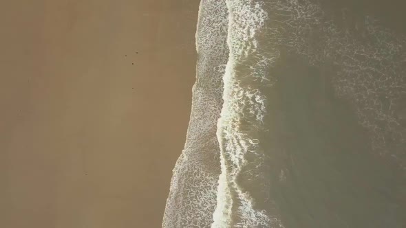 Aerial birds eye view drone footage of waves crashing onto the beach, Seaburn Beach, Sunderland. alt