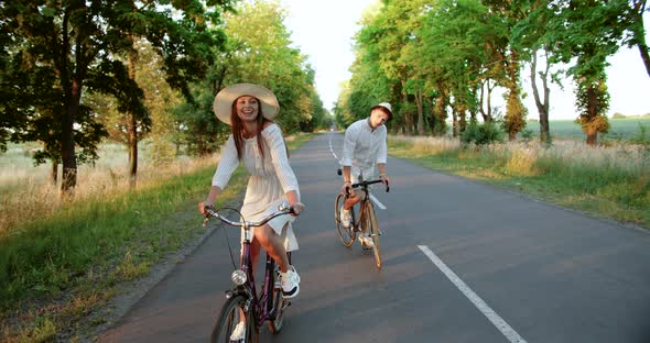 Couple Riding Bicycles on Countryside Road