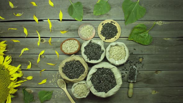 Seeds and sunflowers on an old wooden table. Top view. alt