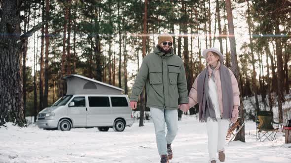 Romantic Couple Walk on Their Camp Holding Hands Enjoying Van Life alt