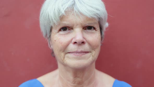 Authentic Shot of Happy Senior Woman Looking at Camera Outdoor alt