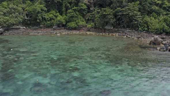 Moving in And Panning up View of The Rocky Beach in Tenggol Island