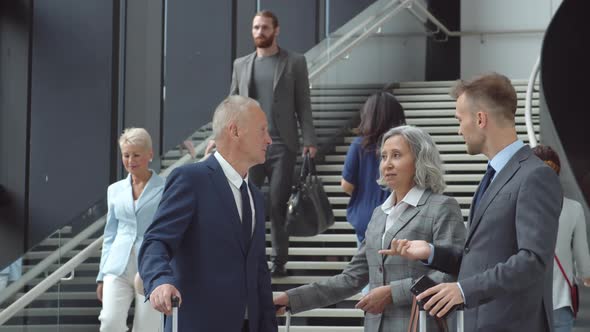 Three Colleagues Chatting in Airport alt