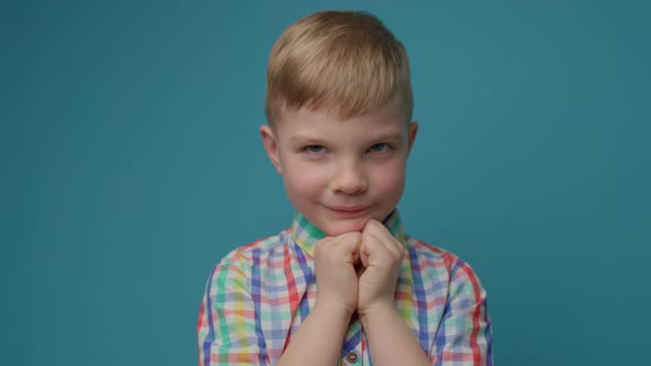 Kid Pleading Holding Hands Folded Standing Isolated on Blue Background