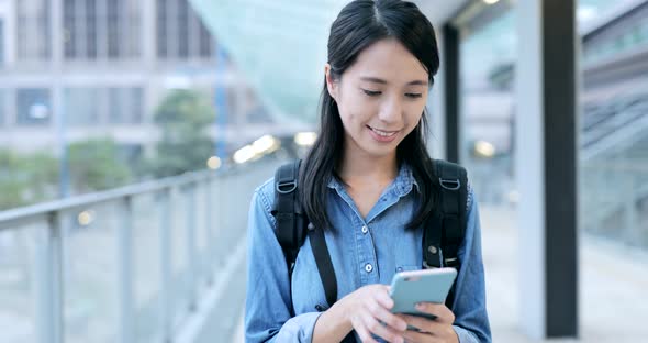 Young Student Working on Smartphone in The City  alt