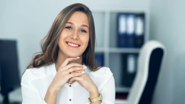 Cheerful Businesswoman Sitting at the Table in Office and Looking at Camera alt