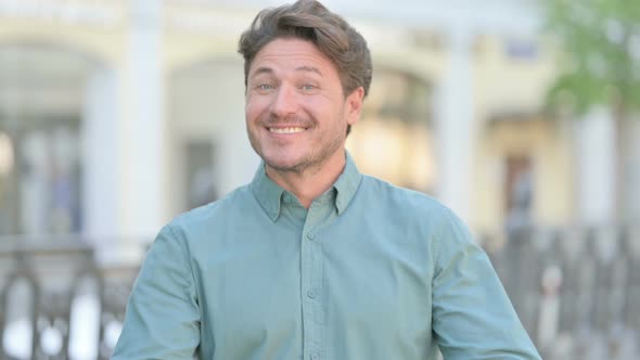 Outdoor Man showing Heart Shape by Hands alt