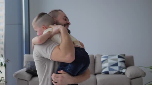 Little boy Son runs to his father hugs