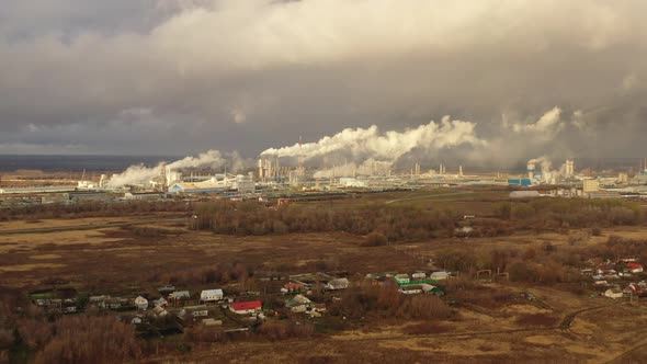 White Smoke Comes Out of a Large Number of Tall Chimneys of Chemical Plants Against the Backdrop of alt
