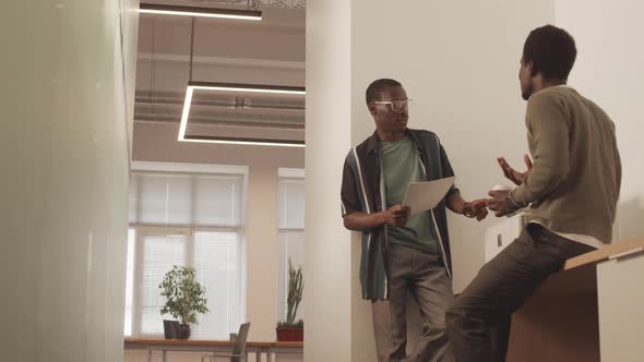 Men Having Conversation in Office alt