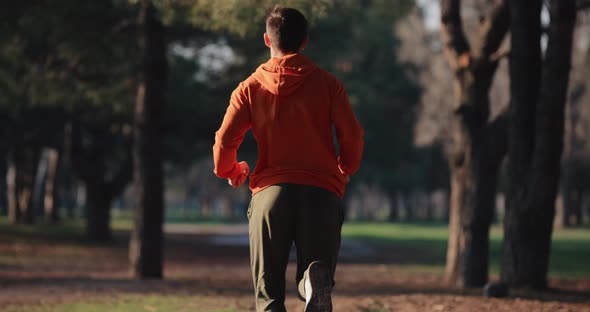 A Man Jogging Running in a Park Slow Motion Back View alt