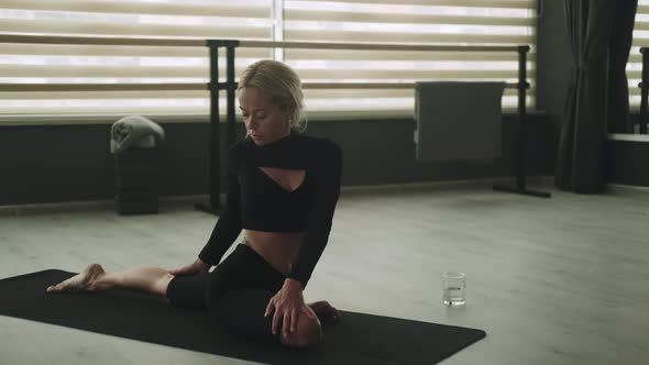 Flexible Female Practicing Yoga in Studio