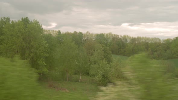 View From Window of Highspeed Train on Landscape of Beautiful Nature Wild Field and Forest on alt