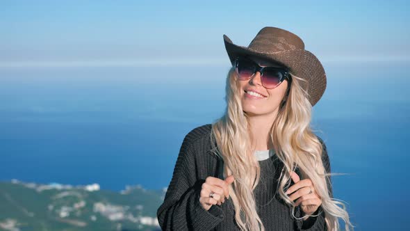 Portrait of Elegance Young European Woman in Cowboy Hat and Sunglasses Smiling and Flirting alt