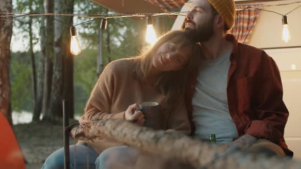 Romantic Couple Bonding by Campfire in Evening alt