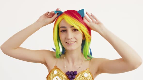 Youthful Caucasian Chick Fooling Around with Her Cat Ears Medium Close Up Studio Shot White alt