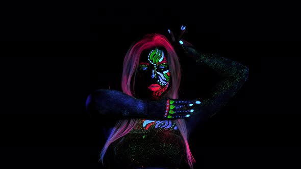 Beautiful Female Fashion Model Posing and Looking in Camera. Ultra Violet Lenses Glows in Her Eyes alt