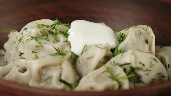 Adding Sour Cream Into Boiled Dumplings on Board Closeup Cooking Dough Products with Meat alt