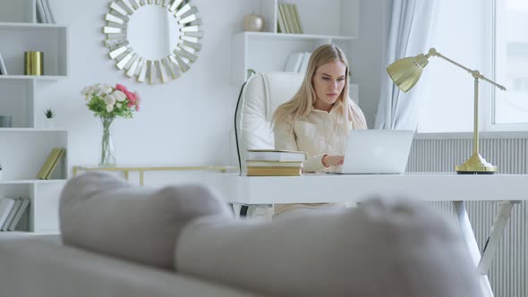 Unhappy businesswoman typing on laptop at home office. Young girl closing laptop alt