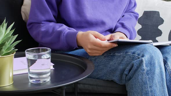 Woman reading a book in a cozy living room, the concept of home schooling. alt