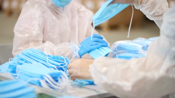 Production of Medical Masks - Staff Packing the Masks in Piles alt