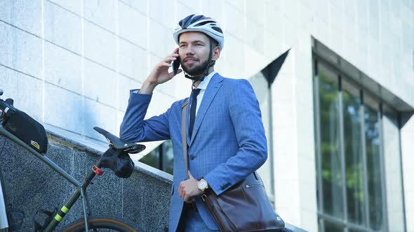 Bearded Businessman Outdoors Talking By Mobile Phone