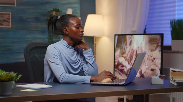 Overworked Black Entrepreneur Working From Home Late at Night alt