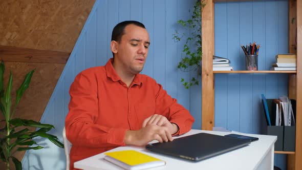 Young Man in Office is Overworked and Tired alt