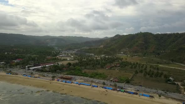 Refugees tent emergency camp on the beach.Daring aerial view flight panorama overview drone footage alt